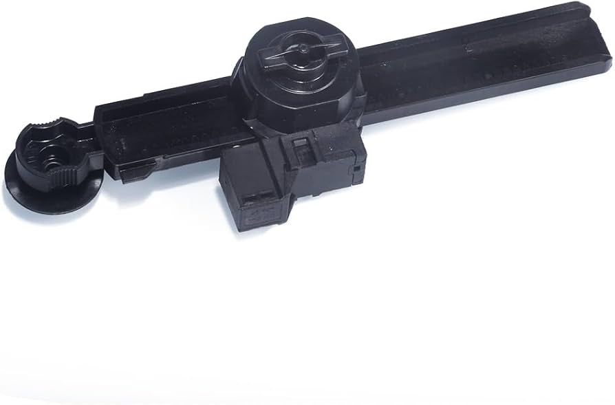 A mechanic's hand unclipping a small plastic damper arm on the side of a glove box so it can drop down further