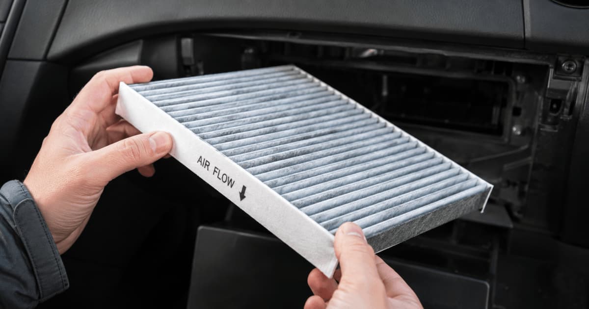A new cabin air filter showing the airflow direction arrow molded into the plastic frame